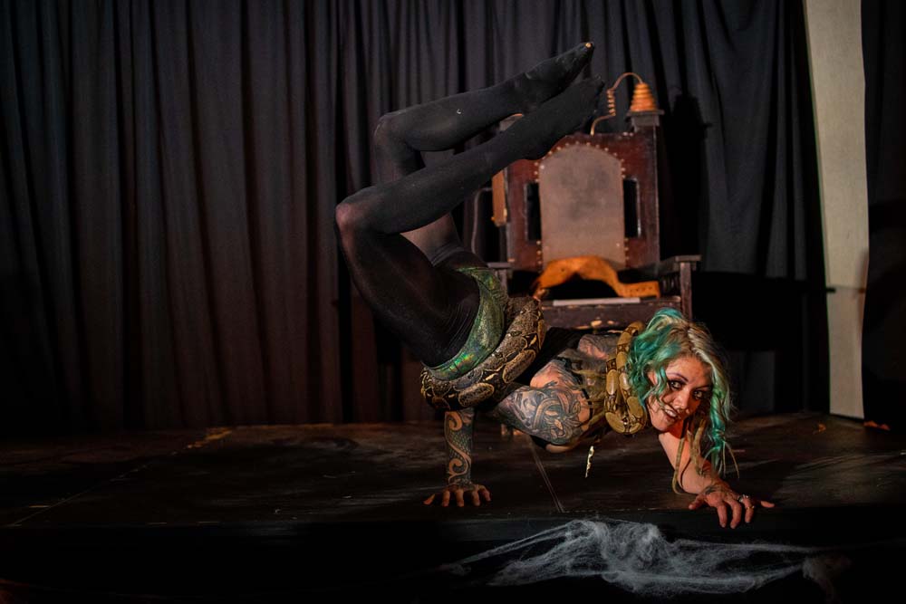 Snake Charming Contortionist - Photo by Cage and Aquarium